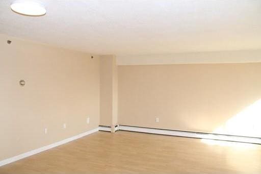 spare room featuring light hardwood / wood-style floors