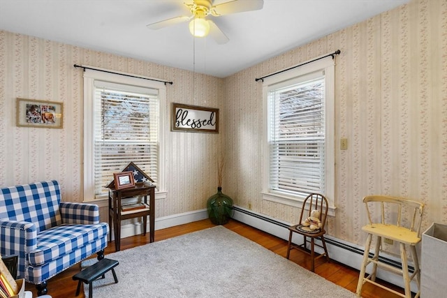 living area featuring wallpapered walls and wood finished floors