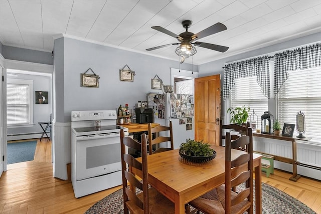 dining room featuring light wood-style floors, baseboard heating, and ceiling fan