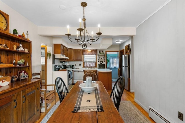 dining area featuring light wood-style floors, baseboards, baseboard heating, and a chandelier