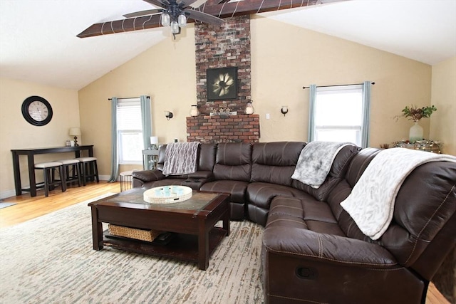 living room with lofted ceiling, hardwood / wood-style flooring, and ceiling fan