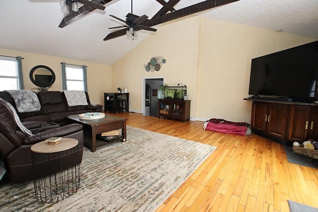 living room featuring ceiling fan, a healthy amount of sunlight, and light wood-type flooring