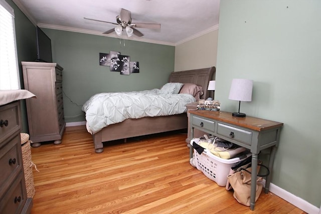 bedroom featuring crown molding, ceiling fan, and light hardwood / wood-style floors