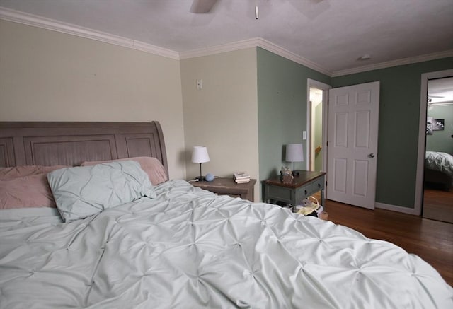 bedroom with crown molding, dark hardwood / wood-style floors, and ceiling fan