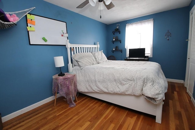 bedroom with hardwood / wood-style flooring and ceiling fan