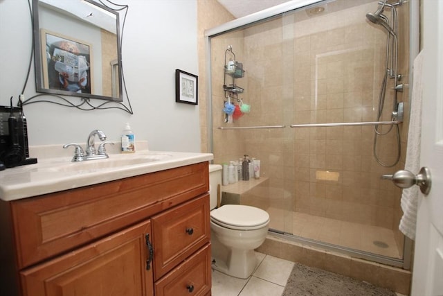 bathroom with tile patterned flooring, vanity, toilet, and walk in shower