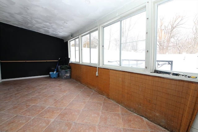 unfurnished sunroom with vaulted ceiling