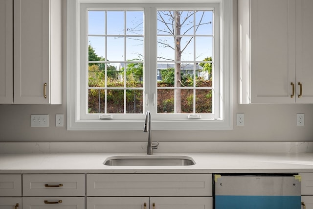 kitchen with white cabinets, dishwasher, a healthy amount of sunlight, and sink