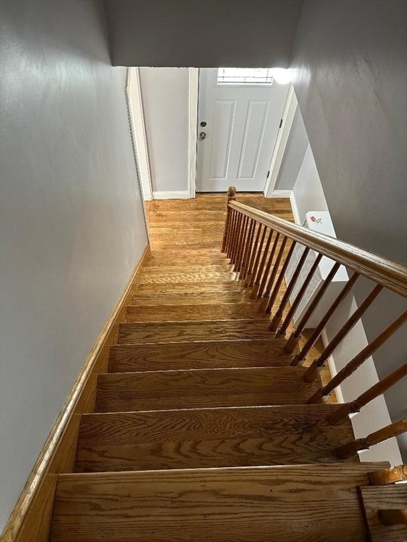 stairs featuring wood-type flooring