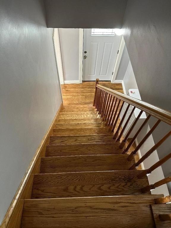 stairs featuring wood finished floors