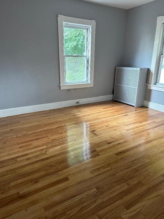 empty room with wood finished floors and baseboards