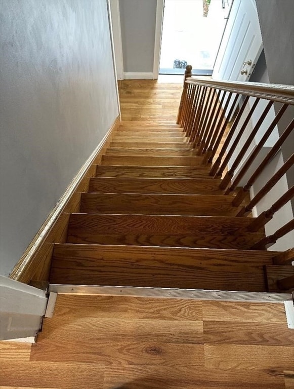 stairs featuring hardwood / wood-style flooring