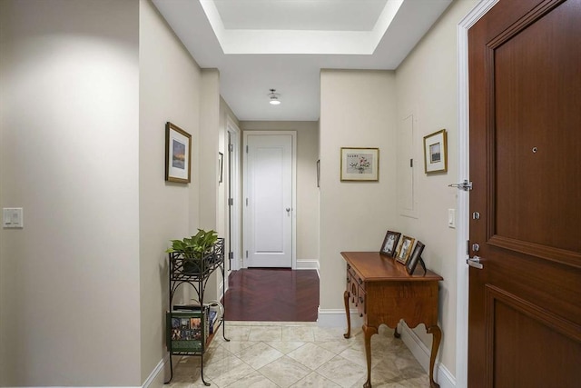 1 Charles St S Unit 602, Boston, MA 02116 - corridor with baseboards, a raised ceiling, and light marble finish floors