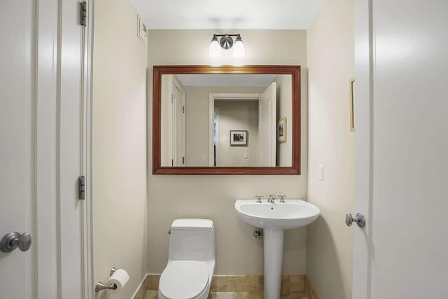 1 Charles St S Unit 602, Boston, MA 02116 - bathroom with toilet, a sink, and baseboards