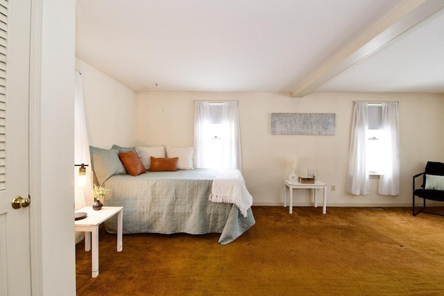 bedroom with dark carpet, beam ceiling, and baseboards