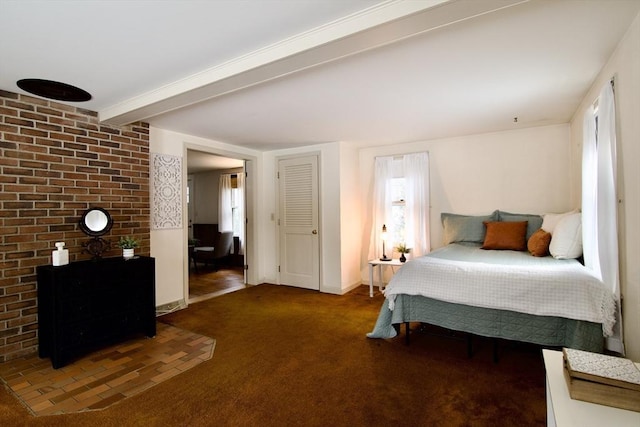 bedroom with dark colored carpet, beam ceiling, a fireplace, and baseboards