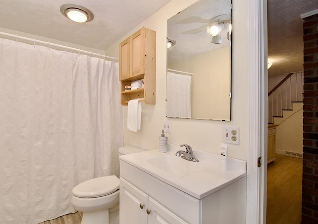 full bathroom featuring a ceiling fan, vanity, toilet, and wood finished floors