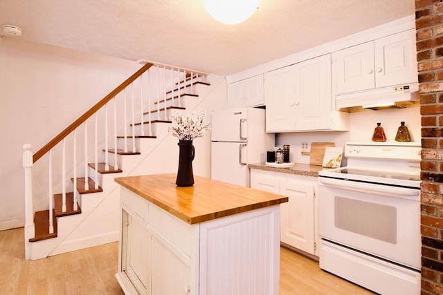 kitchen featuring under cabinet range hood, white appliances, white cabinets, light wood-type flooring, and a center island