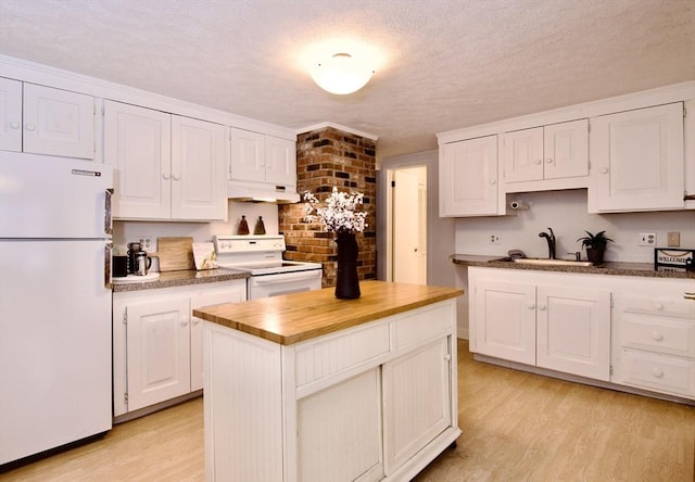 kitchen featuring white cabinets, a kitchen island, a sink, white appliances, and under cabinet range hood