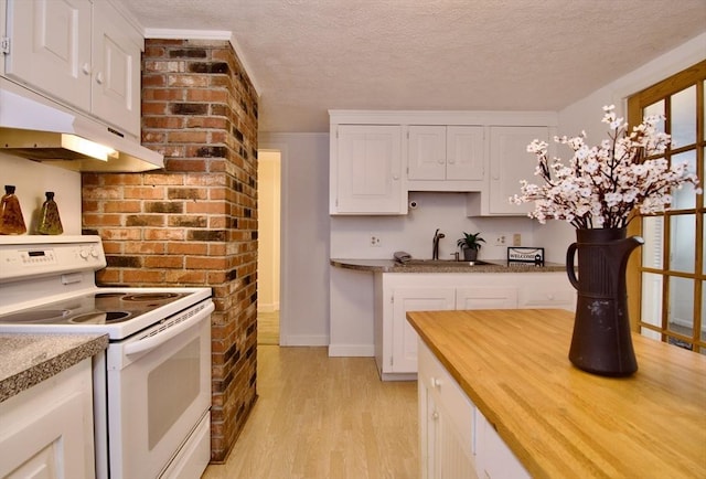 kitchen featuring a textured ceiling, light countertops, electric range, and white cabinets