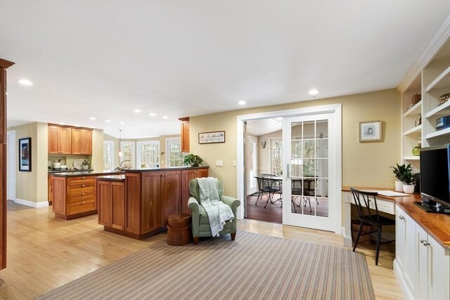 kitchen featuring dark countertops, recessed lighting, french doors, light wood-style floors, and baseboards