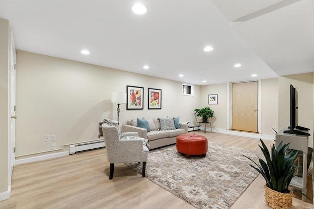 living area featuring recessed lighting, baseboards, light wood-style floors, and a baseboard radiator