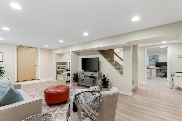 living room with stairs, light wood-style flooring, recessed lighting, and baseboards