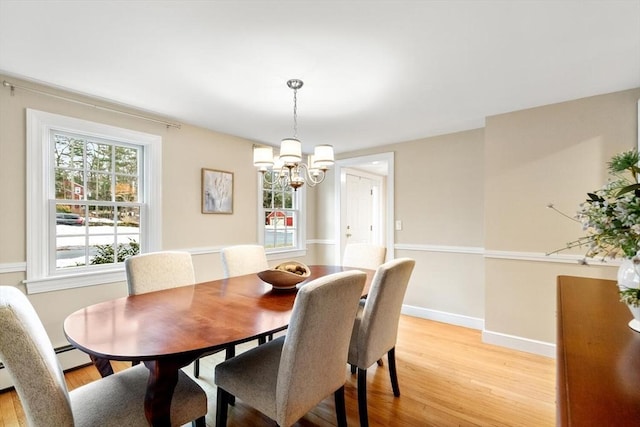 dining area featuring a wealth of natural light, light wood-style flooring, and baseboards