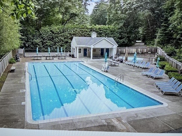 pool featuring a patio area and fence