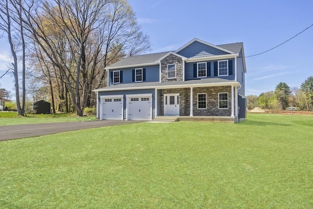 15 Fernwood Dr, East Longmeadow, MA 01028 - view of front facade with driveway, stone siding, a garage, a front yard, and covered porch
