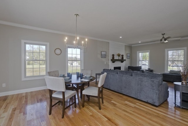 15 Fernwood Dr, East Longmeadow, MA 01028 - dining space with crown molding, light wood-style flooring, a fireplace, baseboards, and a chandelier
