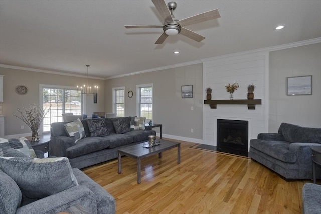 15 Fernwood Dr, East Longmeadow, MA 01028 - living area featuring a chandelier, a ceiling fan, baseboards, ornamental molding, and a large fireplace
