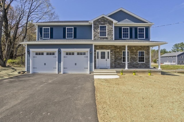 15 Fernwood Dr, East Longmeadow, MA 01028 - view of front of house featuring driveway, stone siding, an attached garage, and a porch