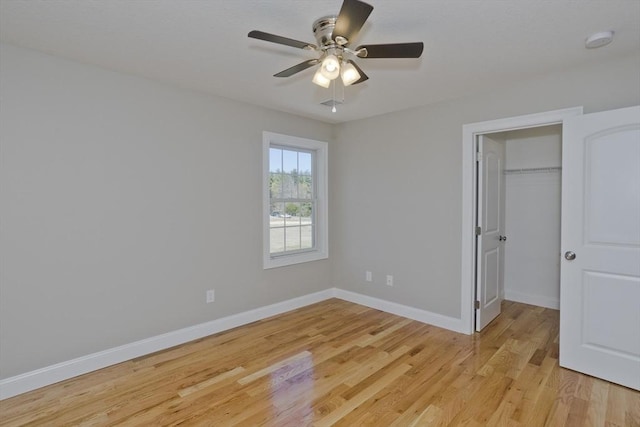 15 Fernwood Dr, East Longmeadow, MA 01028 - unfurnished bedroom featuring light wood-style flooring, baseboards, a spacious closet, ceiling fan, and a closet