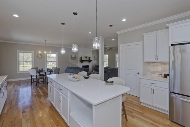 15 Fernwood Dr, East Longmeadow, MA 01028 - kitchen with stainless steel fridge, a ceiling fan, white cabinets, a center island, and light countertops