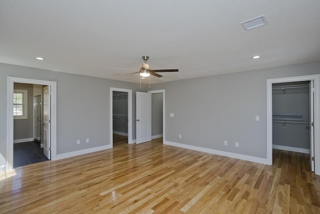 15 Fernwood Dr, East Longmeadow, MA 01028 - unfurnished bedroom featuring a walk in closet, a closet, light wood-style floors, baseboards, and recessed lighting