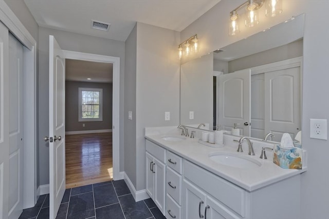 15 Fernwood Dr, East Longmeadow, MA 01028 - bathroom featuring baseboards, double vanity, and tile patterned flooring