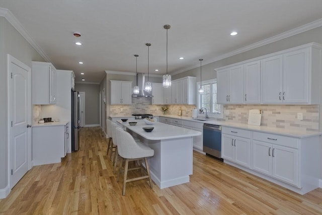 15 Fernwood Dr, East Longmeadow, MA 01028 - kitchen with appliances with stainless steel finishes, wall chimney exhaust hood, a center island, a sink, and white cabinetry