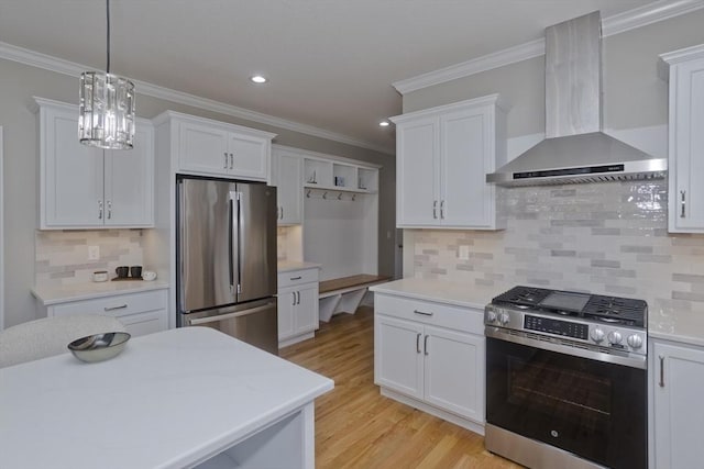 15 Fernwood Dr, East Longmeadow, MA 01028 - kitchen with appliances with stainless steel finishes, wall chimney range hood, crown molding, white cabinets, and light wood-type flooring