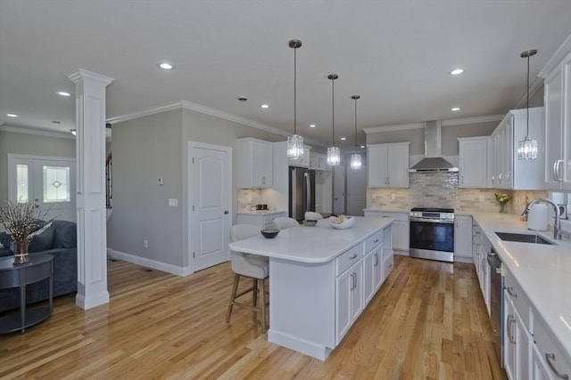 15 Fernwood Dr, East Longmeadow, MA 01028 - kitchen featuring wall chimney exhaust hood, stainless steel appliances, a sink, a kitchen island, and ornamental molding