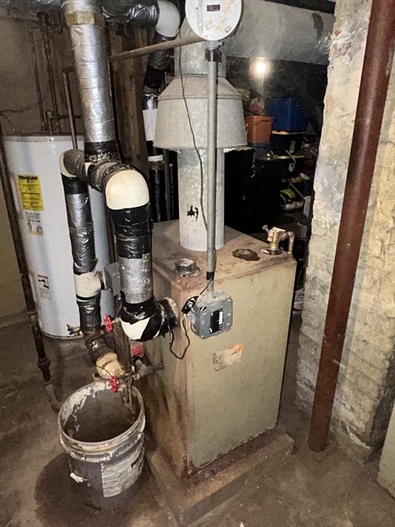 utility room featuring water heater