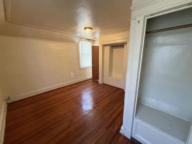 unfurnished bedroom with dark hardwood / wood-style floors