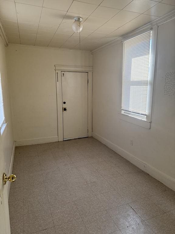 empty room featuring ornamental molding