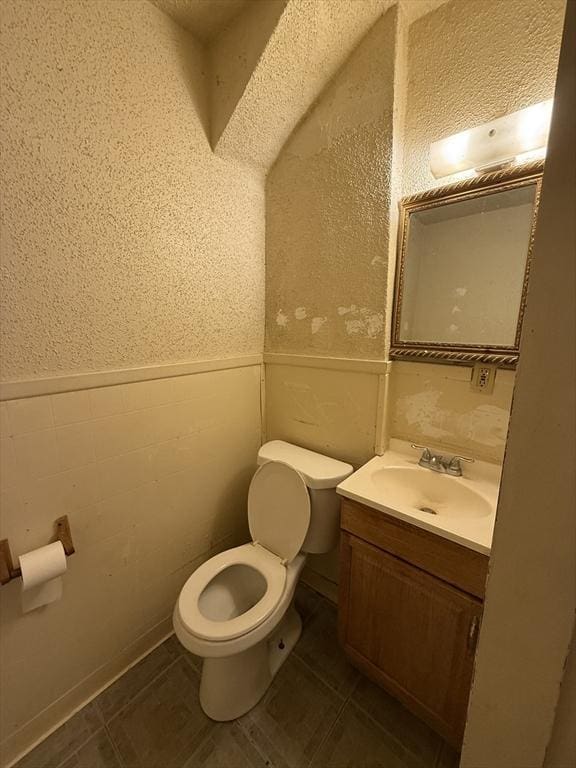 bathroom featuring vanity, tile patterned flooring, and toilet