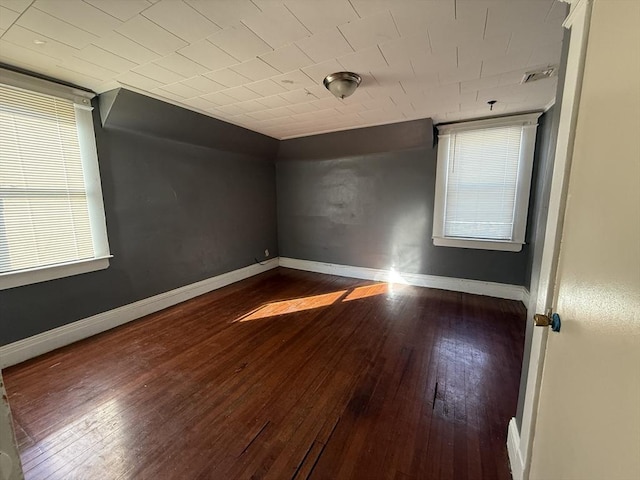 empty room featuring dark wood-type flooring