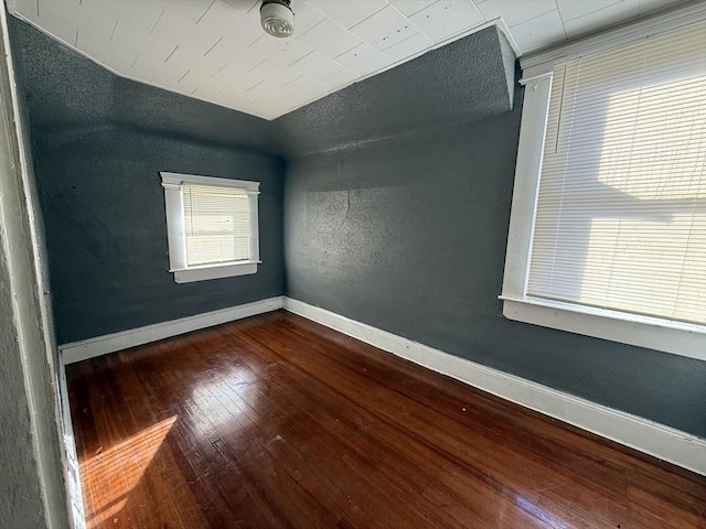 empty room with dark hardwood / wood-style floors