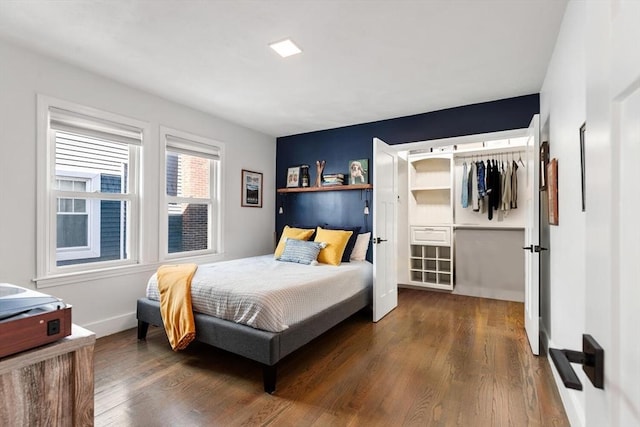 bedroom featuring dark wood-style flooring and baseboards