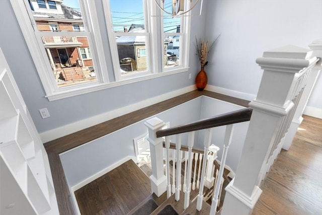 stairway featuring baseboards and wood finished floors