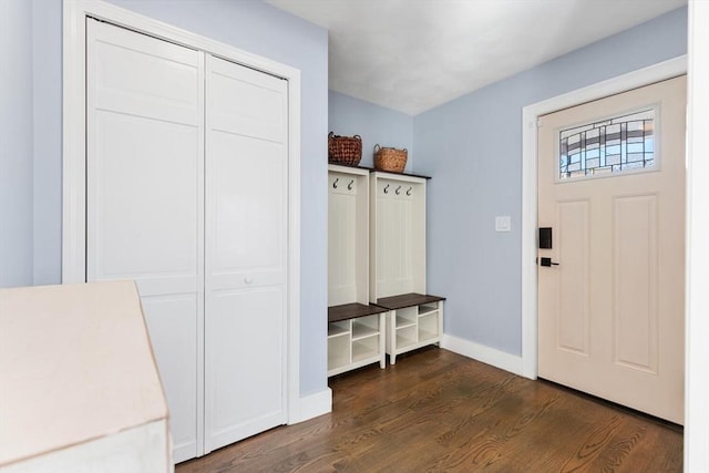 mudroom with dark wood-type flooring and baseboards