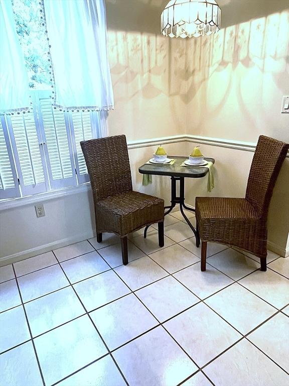 38 Hammond Pl Unit 38, Woburn, MA 01801 - living area featuring light tile patterned floors and a chandelier